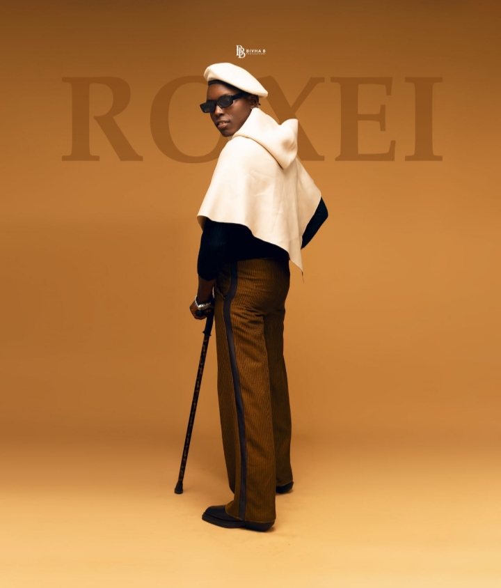 ROXEI signature menswear look with beret and cape